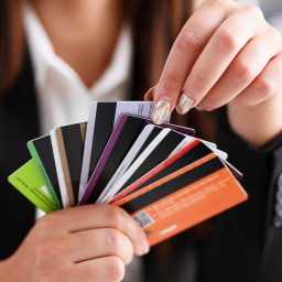 Female arm hold bunch of credit cards picking one closeup. Convenient set of funds, budget wallet deposit, wealth and effective investment, invest resources, income profit concept